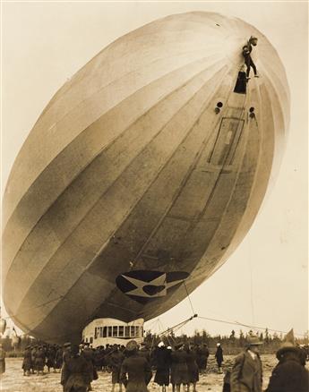 (DIRIGIBLES) A group of 11 photographs depicting dirigibles in air or parked in giant hangers, primarily American vessels.